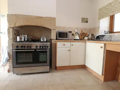 a kitchen with a stove and a microwave at The Proven House in Preston