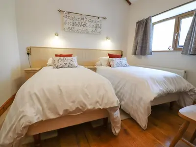 a bedroom with two beds and a window at The Proven House in Preston