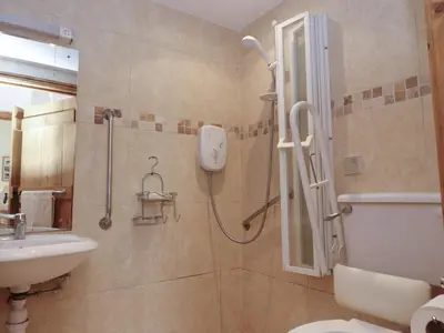 a bathroom with a shower and a toilet and a sink at The Proven House in Preston