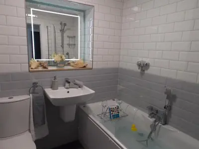 a bathroom with a sink and a toilet and a tub and a mirror at Eden Suite Sasco Apartments in Blackpool