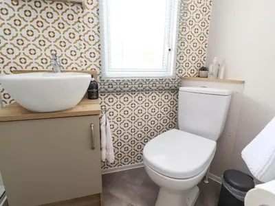 a bathroom with a toilet and a sink at 25 Sherwood in Carnforth