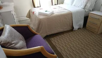 a bedroom with a bed and a chair and a bed at Number 36 in Blackpool