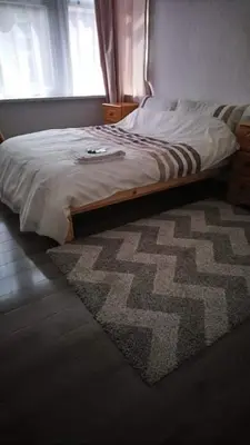 a bedroom with a bed with a rug and a window at Number 36 in Blackpool