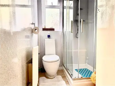 a small bathroom with a toilet and a shower at Number 36 in Blackpool
