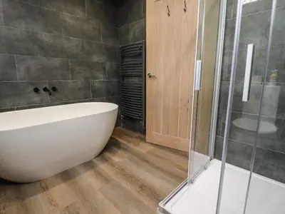 a bathroom with a tub and a glass shower at Box Tree Escapes in Lancaster
