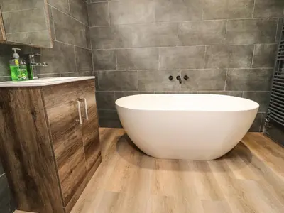 a bathroom with a white tub and a sink at Box Tree Escapes in Lancaster