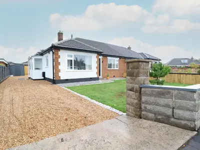 a detached house with a yard and a fence at 2 Pine Grove in Preston