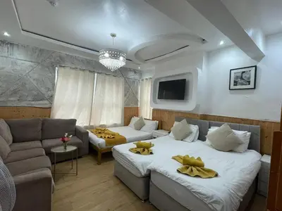 a living room with two beds and a couch at Ariana House Hotel-Families and Couples Only in Blackpool