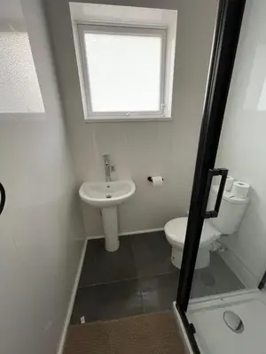 a bathroom with a toilet and a sink and a window at Ariana House Hotel-Families and Couples Only in Blackpool