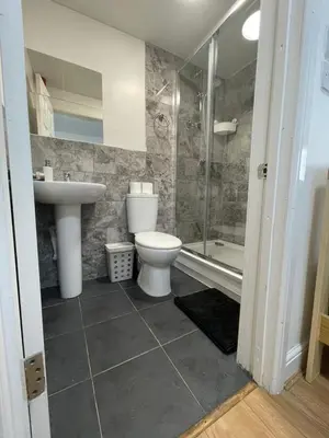 a bathroom with a toilet and a sink and a shower at Ariana House Hotel-Families and Couples Only in Blackpool