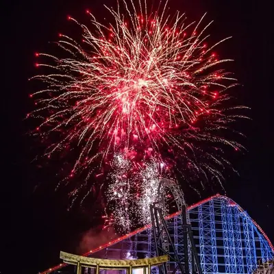 a fireworks display over a roller coaster at Blackpool Apartments in Blackpool