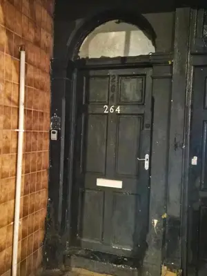a black door with the number on it at Blackpool Apartments in Blackpool