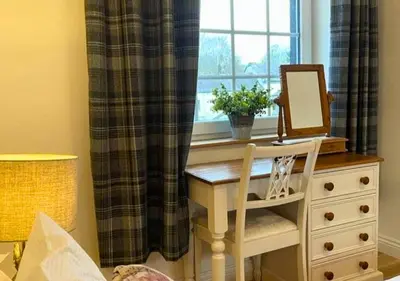 a desk with a mirror on a dresser next to a window at Bowland Breaks - Cobble View Cottage with Private Parking Near all the local Wedding Venues in Waddington