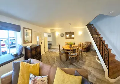 a living room with a couch and a table and a staircase at Bowland Breaks - Cobble View Cottage with Private Parking Near all the local Wedding Venues in Waddington