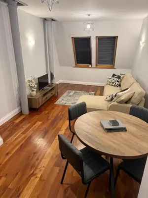 a living room with a table and a couch at Superb City Centre Location in Liverpool