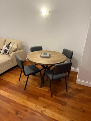 a living room with a table and chairs and a couch at Superb City Centre Location in Liverpool