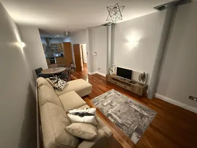 a living room with a couch and a tv at Superb City Centre Location in Liverpool
