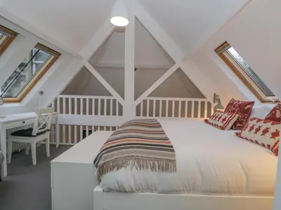 a bedroom with a bed in a attic at Moorhurst Cottage in Grange Over Sands
