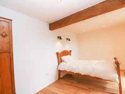 a bedroom with a bed in the corner of a room at Bowland Barn in Lancaster