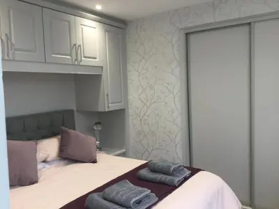 a bedroom with a bed with two towels on it at Leafy Lytham central Lovely ground floor 1 bedroom apartment with private garden In Lytham dog friendly in Lytham St Annes