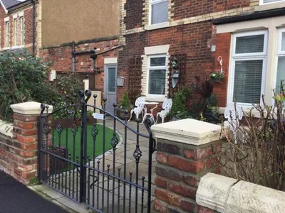 a wrought iron fence in front of a house at Leafy Lytham central Lovely ground floor 1 bedroom apartment with private garden In Lytham dog friendly in Lytham St Annes