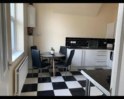 a kitchen with a black and white checkered floor at Marley Mansions Clarendon 65 in Wallasey