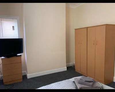 a bedroom with a bed and a flat screen tv at Marley Mansions Clarendon 65 in Wallasey