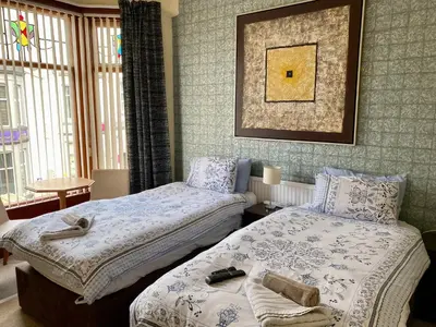 a bedroom with two beds and a picture on the wall at The Rockley Hotel in Blackpool