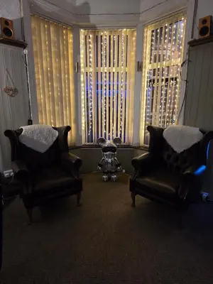 two chairs in a living room with two windows at The Rockley Hotel in Blackpool