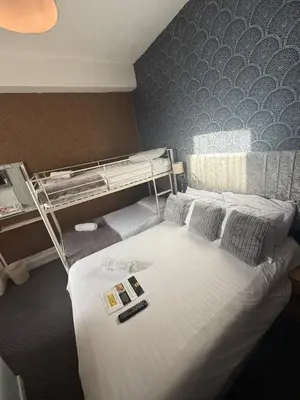 a room with two bunk beds in a hotel room at The Rockley Hotel in Blackpool