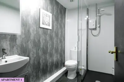 a bathroom with a toilet and a sink and a shower at St Luke's 2 in Liverpool
