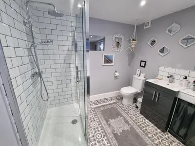a bathroom with a shower and a toilet and a sink at Tiffy's Place in Blackpool