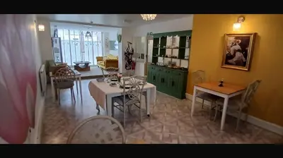 a kitchen and dining room with tables and chairs at Tiffy's Place in Blackpool