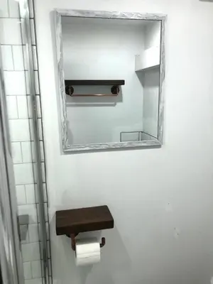 a bathroom with a mirror and a toilet paper dispenser at CLIFTON Apartments in Liverpool