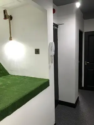 a room with a wall with a phone and green carpet at CLIFTON Apartments in Liverpool