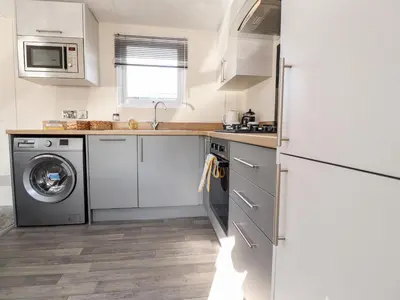 a kitchen with a washing machine and a washer at Hawthorn Lodge in Carnforth