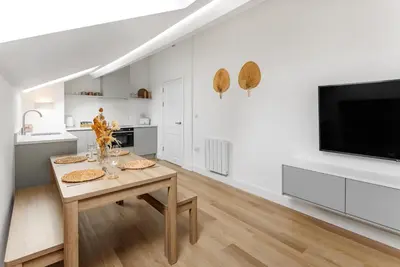 a white kitchen with a table and a tv at 44 Renshaw Apart Hotel in Liverpool