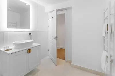 a white bathroom with a sink and a mirror at 44 Renshaw Apart Hotel in Liverpool