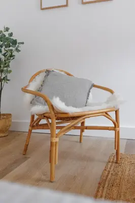 a wicker chair with a blanket on top of it at 44 Renshaw Apart Hotel in Liverpool