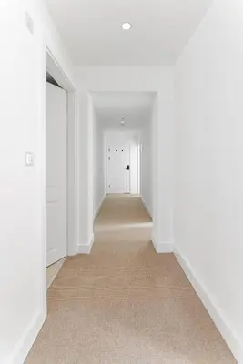 an empty hallway with white walls and a white door at 44 Renshaw Apart Hotel in Liverpool