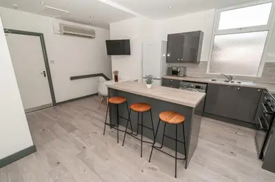 a kitchen with a counter and stools in a room at Beautiful 2 Bedroom Apartment in Fleetwood in Fleetwood