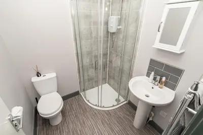 a bathroom with a shower and a toilet and a sink at Beautiful 2 Bedroom Apartment in Fleetwood in Fleetwood