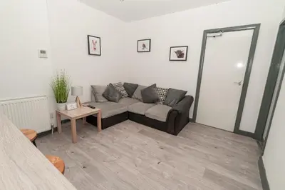 a living room with a couch and a table at Beautiful 2 Bedroom Apartment in Fleetwood in Fleetwood