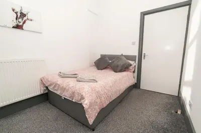 a bedroom with a bed with two shoes on it at Beautiful 2 Bedroom Apartment in Fleetwood in Fleetwood