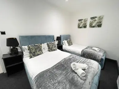 a bedroom with two beds with towels on them at Wellington Suites by Sasco Apartments in Blackpool