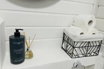 a bottle of soap and a basket of toilet paper at Avril Apartments by CityNest1 in Blackpool