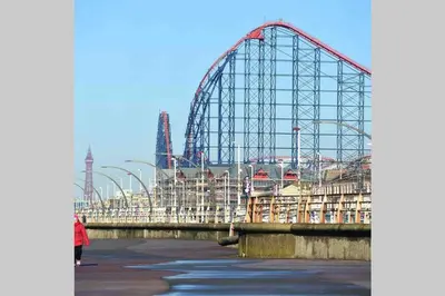 a roller coaster in a park on the water at Avril Apartments by CityNest1 in Blackpool