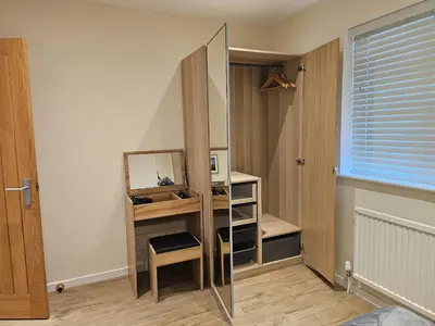 a dressing room with a mirror and a dressing table at Seashells Cottage in Lytham St Annes