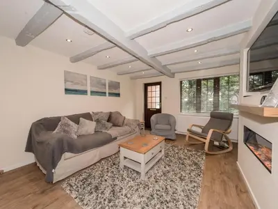 a living room with a couch and a table at Seashells Cottage in Lytham St Annes