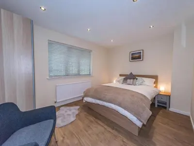 a bedroom with a bed and a window at Seashells Cottage in Lytham St Annes